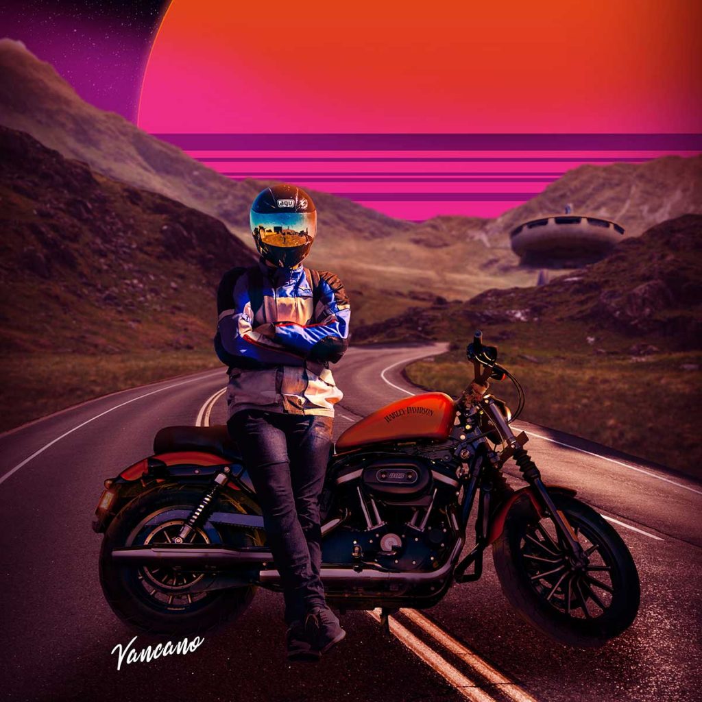 A motorbike is pulled across a road and it's rider sits facing the camera. There is an orange and pink retrowave sun behind mountains.